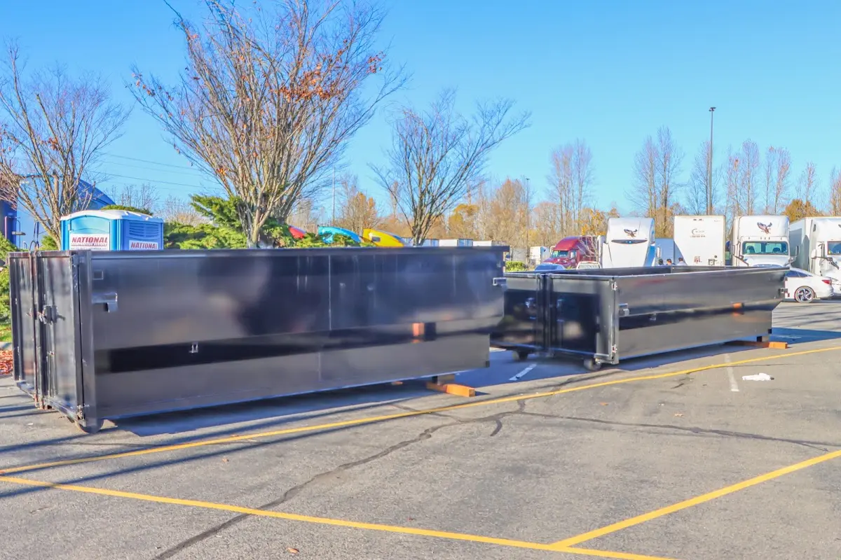 Professional dumpster rental service with roll-off container on residential driveway in Chehalis